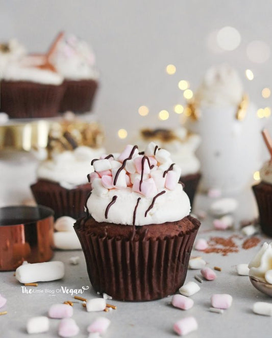 These hot chocolate cupcakes have a chocolate sponge cake filled with a chocolate sauce, with a bulb of vanilla buttercream, topped with vegan marshmallows and a drizzle of dark chocolate